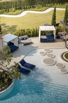 an aerial view of a pool with lounge chairs