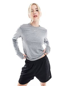 Tops by Nike Running Hit that new PB Crew neck Nike logo print to chest Zip pocket Reflective details for increased visibility in low lighting Thumbhole cuffs prevent sleeves from riding up Regular fit Athleisure Gray Tops With Ribbed Cuffs, Gray Athleisure Tops With Ribbed Cuffs, Sporty Heather Grey Long Sleeve Activewear, Heather Grey Long Sleeve Sporty Activewear, Heather Grey Long Sleeve Athleisure Activewear, Athletic Heather Long Sleeve Moisture-wicking Activewear, Moisture-wicking Long Sleeve Activewear In Athletic Heather, Long Sleeve Moisture-wicking Activewear In Athletic Heather, Gray Long Sleeve Activewear For Workout