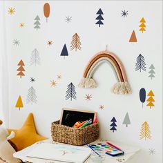 a child's room with trees, stars and a rainbow wall sticker on the wall