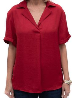 Take a look at our beautiful Ruby Red Notch Collar Short Sleeve Blouse Soft silky fabric Super soft 100% microfiber fabric Color: Ruby Red Semi loose body with short sleeves Notch collar with a pleat detail in the front Back has a yoke and decorative small buttons Center back length is 25" Classic Short Sleeve Viscose Blouse, Short Sleeve Viscose Blouse, Versatile Short Sleeve Viscose Blouse, Elegant Short Sleeve Viscose Tops, Versatile Viscose Short Sleeve Blouse, Classic Short Sleeve Rayon Tops, Solid Color Short Sleeve Relaxed Fit Blouse, Chic Short Sleeve Viscose Blouse, Solid Color Short Sleeve Blouse With Relaxed Fit