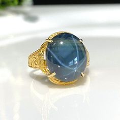 a gold ring with a blue stone in it