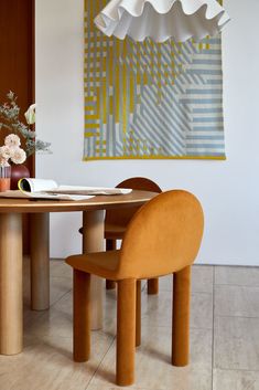 a wooden table with two chairs around it