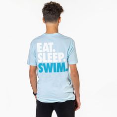 a young man wearing a blue t - shirt with the words eat sleep swim printed on it