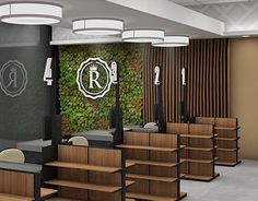 the interior of an office building with wooden desks and chairs in front of a green wall