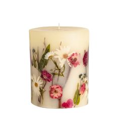 a white candle with flowers painted on it