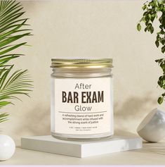 a jar of bar exam glow sitting on top of a table next to a potted plant