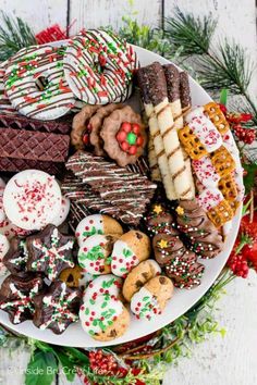 a platter full of christmas cookies and pastries