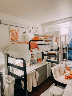 a bedroom with bunk beds and desks in the corner, along with other furniture