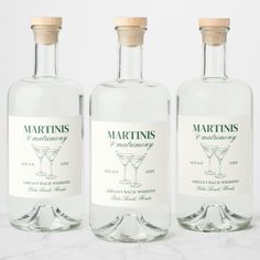 three bottles of martinis on a marble surface