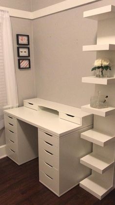 a white desk with shelves and drawers in a room that has hardwood floors, a window, and a door