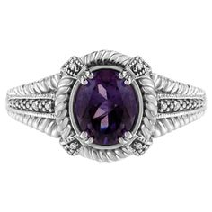 Set your style alight with this exquisite ring, where sterling silver, purple amethyst, and natural white diamonds come together to create a captivating piece of jewelry. This beautiful ring is a stunning expression of craftsmanship and design, embodying both elegance and a timeless charm. The unique allure of this piece lies in its central attraction: a large, oval-cut, natural purple amethyst. This 9x7 mm gemstone is renowned for its deep, royal hue and is securely prong-set, creating a bold statement that is both striking and stylish. The amethyst is further enhanced by eight round-cut, natural white diamonds, meticulously pave-set to maximize their sparkle. These diamonds, with a color rating of I-J and a clarity of I1-I2, collectively weigh 0.032 cttw, adding a hint of dazzling brilli Oval Amethyst Ring, Amethyst And Diamond Ring, Amethyst Gemstone, Sparkle Diamonds, Oval Diamond, Amethyst Ring, Purple Amethyst, Oval Shape, Diamond White