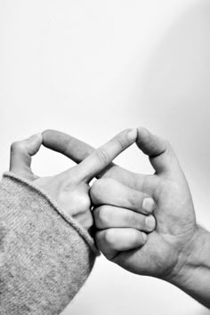 black and white photograph of two hands making the shape of a v with their fingers