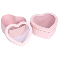 two pink heart shaped boxes sitting next to each other