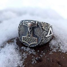 The Mjolnir ring is made by hand casting from Silver solid (without stamp). The Thors hammer version was taken from archeological artefact found in Skane (Sweden). Thurisaz runes are depicted on the sides of signet ring. Thurisaz rune is rune of Norse God Thor and it means courage. If you like Nordic or Viking jewelry for men or women - you`ll like this signet ring. Description of Mjolnir silver ring: Material : Sterling silver solid (92.5% silver, 7.5% copper) without stamp. The ring is made fo Ring Designs For Men Silver, Viking Rings For Men, Thurisaz Rune, Nordic Jewelry, Viking Cosplay, Hunting Wedding, Viking Warriors, Hand Casting, Mens Ring Designs