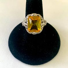 A Candescent Sterling Ring With A Faceted Simulated Citrine Gemstone In A High 4 Prong Filigree Setting. The Workmanship Is Magnificent. A Genuinely Wardrobe Statement Piece. Size 6. Please See All Photos For Full Description Before Purchase. Questions, Please Ask. #Q11 Yellow Crystal Ring For Promise, Yellow Topaz Ring For Wedding, Yellow Topaz Ring As A Gift, Elegant Adjustable Yellow Ring, Elegant Yellow Adjustable Ring, 6 Rings, Ring Color, Citrine Gemstone, Filigree Ring