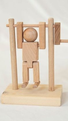 a wooden toy standing in front of a white background