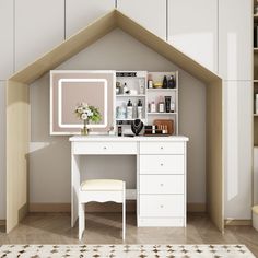 a white desk and chair in a room with shelves on the wall behind it,