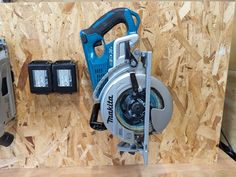 a cordless circular saw and power tool on plywood