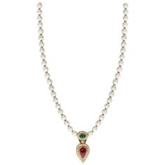 A Cultured Pearl Necklace with an Oval Emerald Cabochon, a Pear-Shape Ruby Cabochon, and Diamonds on the pendant and on the clasp as well. Each bead has a gold spacer in between. The length of the entire necklace from the clasp to the bottom of the ruby pendant is 22 Inches. Total Weight: 48.35 grams. Emerald Cabochon, Cultured Pearl Necklace, Ruby Pendant, Cultured Pearls, Pear Shape, Pear Shaped, Pearl Necklace, Pear, Vintage Jewelry