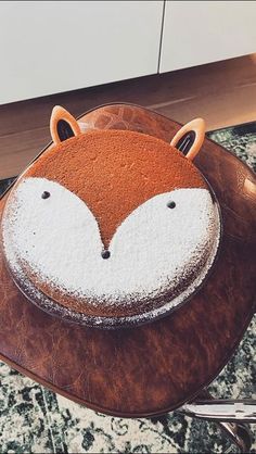 a cake shaped like a fox sitting on top of a table