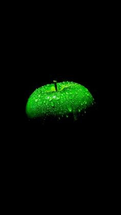 an apple covered in green water on a black background with the word, i am not sure what this image is