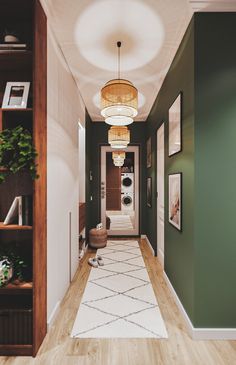 a long hallway with green walls and white rugs on the wooden floor, along with hanging planters