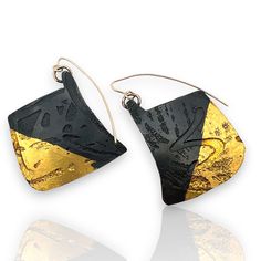 Gold & Steel Earrings - These earrings are made of steel that has been patinated black, giving them a dark, matte finish; they feature a distinctive etched design with a striking contrast between the black patinated steel and the vibrant 24k gold foil, applied using the ancient keum-bo technique. The earrings are asymmetrically shaped with irregular, angular forms, adding a modern and artistic touch. Gold-filled ear wires. Hand Forged Black Earrings For A Gift, Hand Forged Black Earrings As A Gift, Contemporary Black Jewelry With Oxidized Finish, Black Drop Earrings With Oxidized Finish, Line Earrings, Butter Shrimp, Porcelain Earrings, Steel Earrings, Paper Jewelry