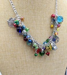 "Old Fashioned Christmas Charm Necklace Search my shop for \"Christmas\" to find matching bracelet and earrings. Chain is 18\" long with a 3\" extension chain.  It has a lobster claw closure. The stainless steel chain links are filled with a rainbow of glass and gem stone beads and crystals - really pretty. Mixed between the beads and gemstones are vintage Christmas themed charms and tiny jingle bells. This makes a great gift or the perfect holiday accessory for yourself! Your necklace will be c Whimsical Multicolor Jewelry With Dangling Charms, Whimsical Multicolor Jewelry With Charms, Whimsical Multicolor Charms Jewelry, Multicolor Charm Necklace With Dangling Charms As Gift, Multicolor Charm Necklaces With Dangling Charms As Gift, Whimsical Multicolor Personalized Jewelry, Rainbow Metal Jewelry For Jewelry Making, Multicolor Dangling Charms Jewelry For Party, Whimsical Multicolor Charm Necklaces With Lobster Clasp