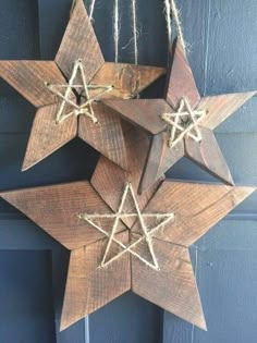 three wooden stars hanging from a door