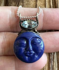 "Lapis Lazuli and Blue Topaz Sterling Silver Pendant 1-5/16\" L by 13/16\" W Carved Lapis gem is 19x19mm. Blue Topaz is 11x5mm. 4.4g Sterling Silver, stamped 925. *Hand carved Lapis gem has a detailed face design and is accented by a marquise Blue Topaz. Pendant is oxidized and has a vintage vibe. 18\" Ball Chain is optional and is 1mm wide, Sterling Silver and 2g. *Please check out my Etsy store for more one of a kind, handmade pieces that feature genuine gemstones and Sterling Silver. I love t Spiritual Blue Jewelry With Gemstone Accents, Spiritual Blue Topaz Jewelry In Blue, Spiritual Blue Gemstones With Accents, Faceted Blue Sterling Silver Gemstones, Handmade Blue Gemstones, Blue Round Natural Gemstones, Natural Blue Round Gemstones, Blue Gemstone Celestial Necklace, Unique Blue Natural Gemstones