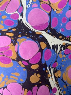 an abstract painting with pink, orange and blue circles on it's surface is shown