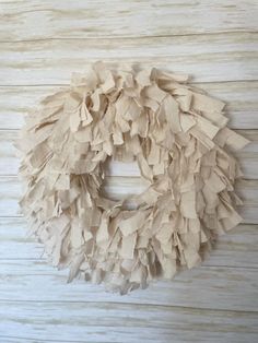 a wreath made out of paper sitting on top of a wooden table