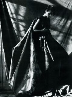 a black and white photo of a woman in a dress