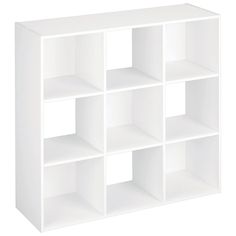 a white shelf unit with six shelves on each side and four smaller ones in the middle