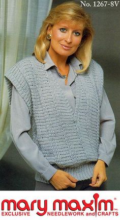 a woman wearing a gray sweater and black pants