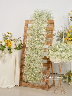 two wooden crates with flowers on them sitting next to each other