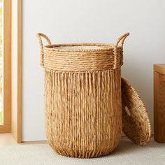 a basket sitting on the floor next to a window