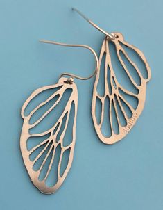 "A real cicada wing was traced to reveal every vein & line. The design was then laser cut onto thick stainless steel, making the spindly lines become the framework to a pair of beautiful silvery wings. The steel has a brushed texture & is smoothed along the sides. I have two versions of this earring. This one is modeled after the lower, smaller set of wings that are found on the cicada. The wings are a mirror image of each other. The wing portion measures 1.25\" long. With earwires they Bug Wings, Line Earrings, The Wing, Silver Spoons, Wing Earrings, The Wings, Mirror Image, Handmade Sterling Silver, Full Time