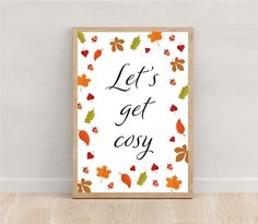 an autumn print with leaves and the words let's get cozy