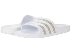 adidas Adilette Aqua Slides - Athletic Shoes : White/Platin Metallic/White : adidas Adilette Aqua Slides feature a classic slip-on style slide with three stripes. Synthetic upper. Synthetic lining and insole. Synthetic outsole. Imported. Measurements: Weight: 4 oz Product measurements were taken using size Men's 8, Women's 9, width Medium. Please note that measurements may vary by size. Weight of footwear is based on a single item, not a pair. Sporty Adidas Slides Suitable For Water, Sporty Adidas Slides For Swimming, Adidas Slides For Swimming With Synthetic Material, Adidas Logo Synthetic Slides For Swimming, Sporty Adidas Slides For Beach, Adidas Slides For Swimming With Logo, Adidas Slides With Logo For Swimming, Casual Adidas Slides For Swimming, Adidas Logo Slides For Swimming In Spring