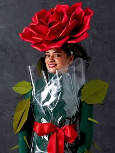 a woman wearing a plastic bag with a rose on it's head