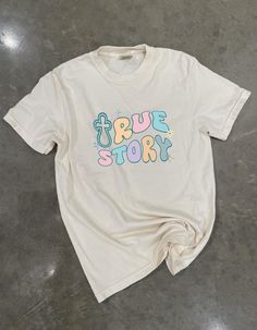 This True Story Graphic shirt can be long sleeve or short sleeve. In the perfect pastel colors for spring. Pastel Long Sleeve Cotton Tops, Cute Cream Tops With Letter Print, Cute Cream T-shirt For Spring, Cute Pastel Tops For Spring, Retro Spring Shirt With Text Print, Cute Pastel Crew Neck Tops, Trendy Pastel Crew Neck Top, Cute Cream Cotton T-shirt, Spring Long Sleeve Shirt With Text Print