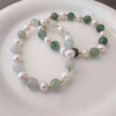 This beautiful bracelet is featuring a elegant combination of type jade rondelles and dainty fresh water pearls. A classic and timeless choice for jade lovers. It can be slipped on and off to add a touch of class to any outfit. Jade bead measure approx. 8mm big, and fresh water pearls measure approx. 6mm big. Each natural freshwater pearl is unique, their size and shape might vary slightly. Made with 14K gold-filled elements. Bracelet measures 6 inches long (15cm) in the pictures. Options of len Elegant Green Pearl Hand-strung Bracelet, Elegant Green Hand-strung Pearl Bracelet, Elegant Green Pearl Bracelet With Natural Stones, Elegant Green Jade Pearl Bracelet, Elegant Green Jade Bracelet, Real Pearl Jewelry, Real Pearl Jewellery, Pearl Bangle, Jade Bracelet