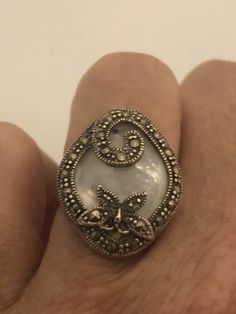 Vintage hand made about an in long Mother of Pearl set in 925 Sterling Silver Marcasite ring I have size 5.5 Can be re sized for you, my jeweler would charge $10 All rings are shipped in a nice gift box. Check out our over a THOUSAND great reviews Engraving is $4 per letter and is not always perfect depending on the piece. It can take a few days if the jeweler is busy. This is payable to Paypal Judithsltd@gmail.com Unique Sterling Silver Butterfly Ring, Vintage Sterling Silver Butterfly Ring For Anniversary, Elegant Silver Hallmarked Butterfly Ring, Elegant Round Butterfly Ring Stamped 925, Sterling Silver Butterfly Ring For Wedding, Unique Sterling Silver Butterfly Ring For Wedding, Elegant Butterfly Wedding Ring Stamped 925, Elegant Wedding Butterfly Ring Stamped 925, Victorian Silver Ring With Stone Setting