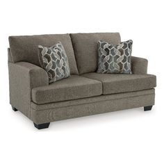 a gray couch with two pillows on it