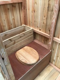 a wooden box with a lid on it in a room filled with wood planks