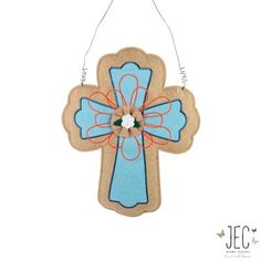 a wooden cross ornament hanging on a wall