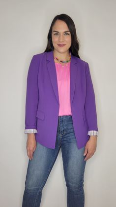 Details: The prettiest quality blazer to add to your closet! The purple is gorgeous and the lining throughout with purple and white stripes is the chef's kiss! The sleeves are full length, but can be cuffed to show off the beautiful lining. Pockets are functional and the flap can be tucked or untucked. Lightweight, comfortable, and smooth material. Light shoulder pads. Collared. Pair it with heels and dress pants or wear it more casual with jeans and sneakers. It would be perfect for kstate fans with a kstate graphic tee. Materials: Self: 100% Polyester. Lining: 95% Polyester, 5% Spandex Made In: China Sizing Tip: It fits like a traditional blazer. Meant to be more fitted. Order true to size or size up if inbetween. There is a little give to the material, but not much. I am 5’7” about 165 Spring Purple Outerwear For Work, Purple Formal Outerwear For Spring, Trendy Purple Blazer For Work, Formal Purple Outerwear For Spring, Trendy Purple Fall Blazer, Purple Formal Blazer For Spring, Purple Spring Formal Blazer, Trendy Purple Long Sleeve Blazer, Trendy Purple Blazer For Fall