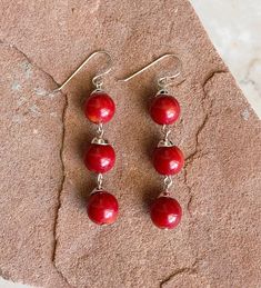 "Vibrant, Southwestern, and versatile dangle earrings that are handcrafted by me! These earrings are comfortable and ideal for everyday wear. They add a pop of color and a Southwestern vibe, making it a must have addition to your outfit! The stone is dyed Red Coral. All findings are 925 sterling silver. Measurements: 2.25\" long with 10mm spherical Red Coral stones. The earrings are dangle earrings with an ear wire. Handcrafted in the USA. The earrings will be packed securely in a gift box. Than Artisan Red Dangle Earrings, Southwestern Red Dangle Earrings, Red Southwestern Dangle Earrings, Southwestern Red Drop Earrings, Nickel-free Southwestern Red Earrings, Southwestern Style Red Dangle Earrings, Nickel-free Red Southwestern Earrings, Artisan Red Drop Earrings, Southwestern Style Red Nickel-free Earrings