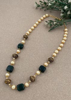 Step into a world of timeless charm with our "Timeless Charm" Traditional Antique Mala, meticulously crafted to celebrate the grandeur of traditional Indian jewelry. This mala features a combination of intricate beads, lush green hydro beads, and lustrous pearls, making it the perfect choice for adding traditional elegance to your attire, whether it's for weddings, special occasions, or cultural celebrations. Materials: Traditional Elements: The mala incorporates traditional Indian design elemen Traditional Long Pearl Necklace Gift, Traditional Oval Handmade Necklace, Traditional Oval Handmade Necklaces, Traditional Handmade Oval Necklace, Long Beaded Necklace With Tilla For Gift, Long Beaded Necklaces With Tilla For Gifts, Elegant Gold Mala As A Gift, Elegant Gold Mala As Gift, Elegant Handmade Necklaces For Diwali